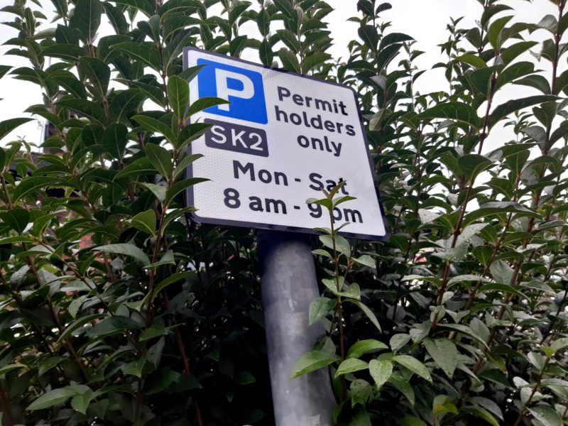 Road sign showing the time in SK2 for permit holders only